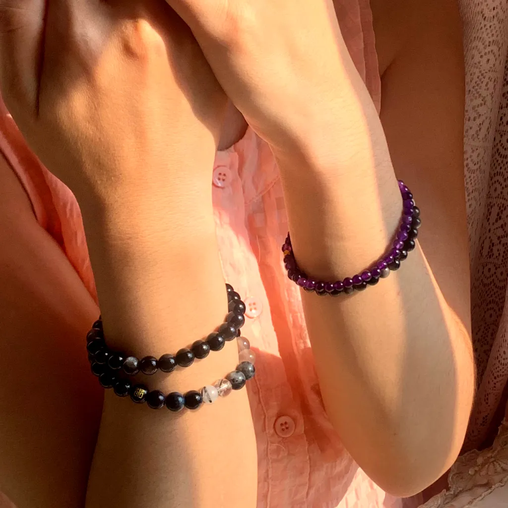 Amethyst Bracelet layered with Obsidian Bracelet on the wrist - a stacked everyday styling